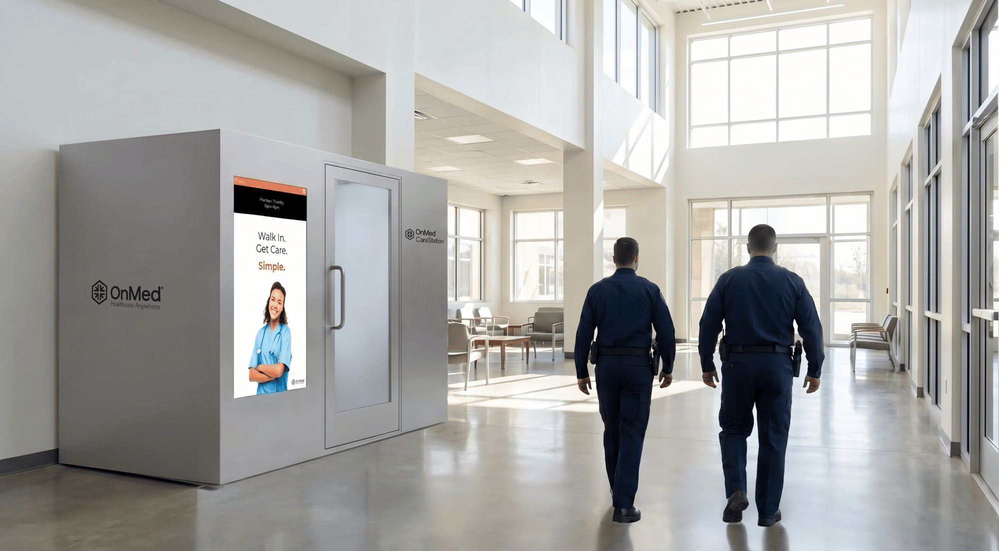 OnMed CareStation telehealth kiosk installed in a correctional facility corridor with two officers walking past, representing onsite healthcare access for incarcerated populations and correctional staff.