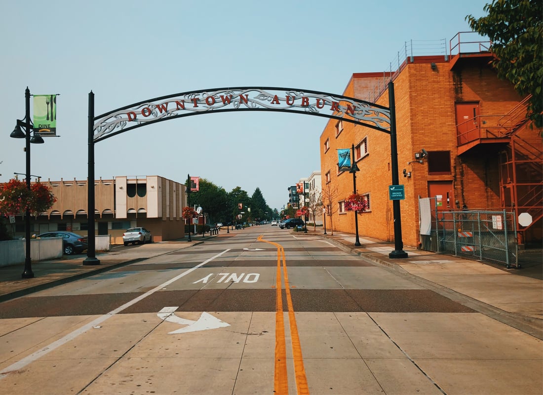 Downtown Auburn street scene with historic brick architecture and community gateway arch, representing small-town healthcare access locations. Downtown Auburn street scene with historic brick architecture and community gateway arch, representing small-town healthcare access locations.
