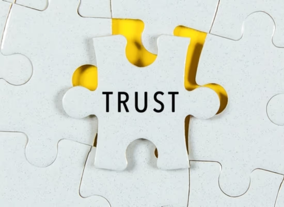 White puzzle piece labeled "Trust" fitting into a yellow-backed puzzle, symbolizing trust in healthcare solutions. White puzzle piece labeled "Trust" fitting into a yellow-backed puzzle, symbolizing trust in healthcare solutions.